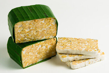 Isolate tempeh wrapped on green banana leaf