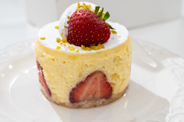 Red fruit sweet dessert cheesecake tart with fresh strawberries in bakery