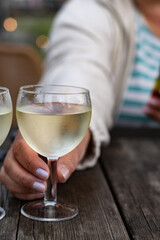 Tasting of Bordeaux white wine, right bank of Gironde Estuary, France. Glasses of white sweet French wine served in outdoor restaurant