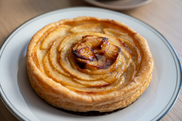 French fresh baked sweet puff pastry with fresh apple fruits in sirup  in confectionery shop