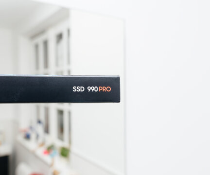 Frankfurt, Germany - Apr 3, 2024: A Samsung SSD 990 Pro is placed in its cardboard packaging, set against a softly defocused room background, highlighting the product in a subtle, ambient setting