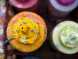 Colorful paint bottles in an old basket