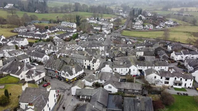 Aerial drone footage of Hawkshead Village and St Michael and All Angels Church.Cumbria UK.