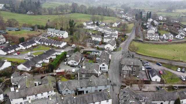 Aerial drone footage of Hawkshead Village and St Michael and All Angels Church.Cumbria UK.