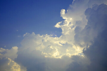 Blue sky background with clouds, Sun rays in the cloudy sky. Nature background.