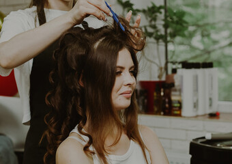 Fototapeta premium Portrait of a young girl at the hairdresser.