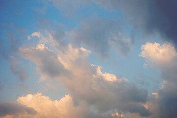 Blue sky background with clouds, Sun rays in the cloudy sky. Nature background.
