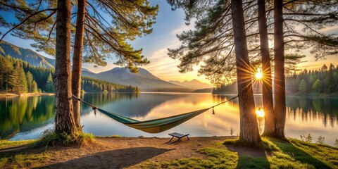 A tranquil camping scene by a mountain lake at sunrise with an empty hammock between two trees