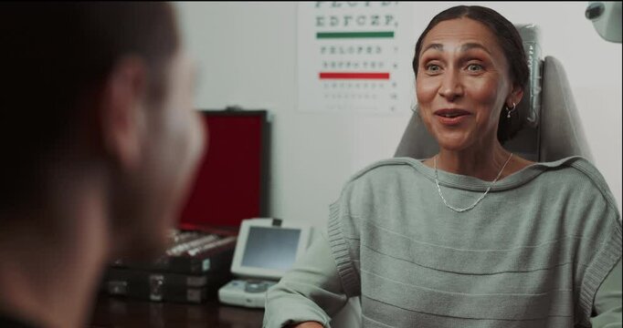 Woman, optometrist and discussion for healthcare at hospital with vision, eye health and medical assessment. Patient, doctor and communication for consultation, glasses prescription and symptoms test