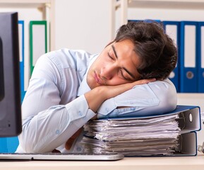 Overloaded busy employee with too much work and paperwork
