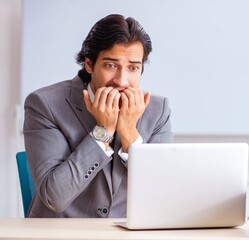 Young handsome businessman employee in the office