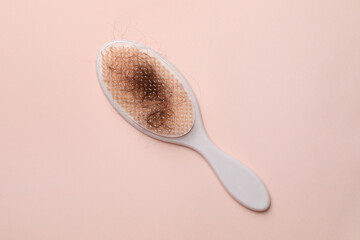 One brush with lost hair on light pink background, top view
