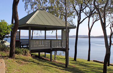 Wooden gazebo pavilion amongst trees overlooking Lake Awoonga near Gladstone in Queensland,...
