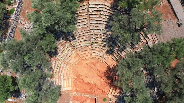 Top down view of Amphitheater with a capacity of 2500 people of Cedrea Ancient City. Also Sanctuary of Apollo, basilica, church buildings and uniquely beautiful Cleopatra Beach the Sedir Island Turkey
