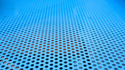 Fototapeta premium Textured of perforated metal sheet, blue color, suitable for industrial theme background