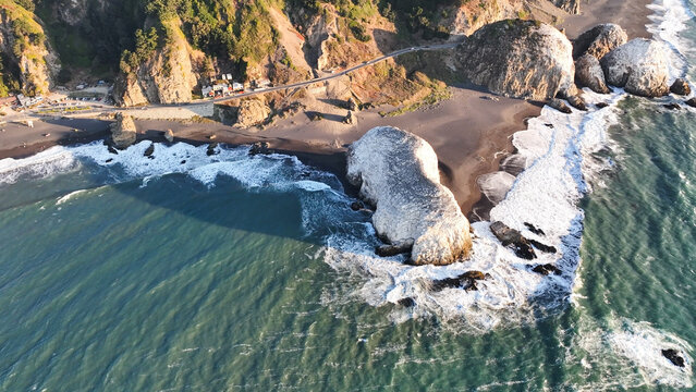 Large rocks natural monument Piedra de Iglecias Church stone on Chilean coast in Constitucion in sunset.