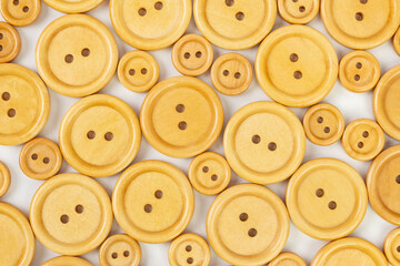 Wooden buttons different size on a white background