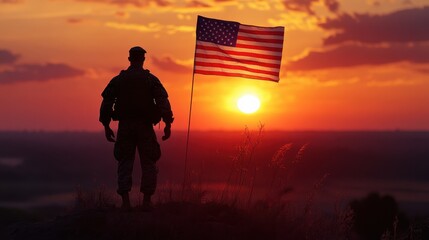 Silhouette of a Soldier Standing at Sunset with the American Flag Waving in the Wind.