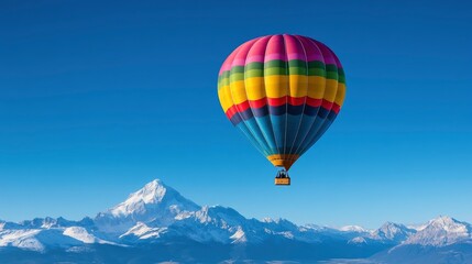 Fototapeta premium Colorful Hot Air Balloon Soaring Over Snowy Mountains