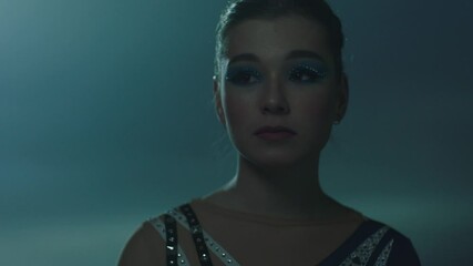 Face of a Girl skater performing alone in the rink