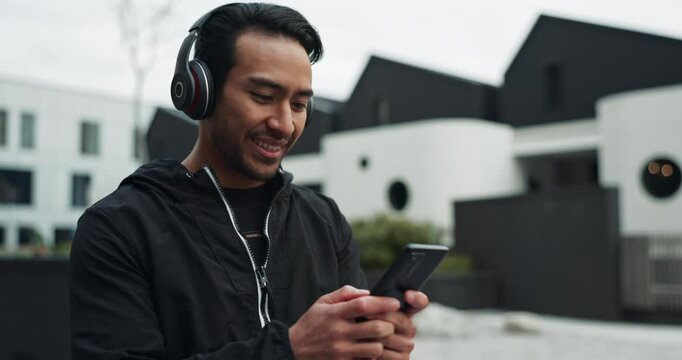 Fitness, man and phone with headphones for walking in neighborhood with morning cardio, exercise and radio. Smartphone, happy and streaming subscription for podcast, music and favorite song outdoor