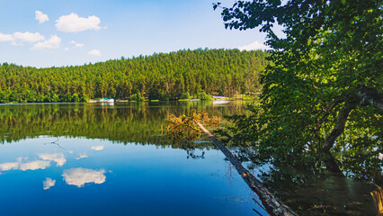 The natural landscape. View of Lake Inyshko, the mountains on the horizon and the forest