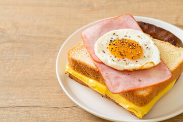 bread toasted cheese topped ham and fried egg with pork sausage
