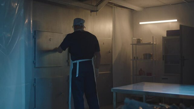 Mortician taking the body out from the freezer
