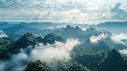 Obraz premium Bird's-eye perspective of limestone peaks amid a stunning sky filled with clouds.