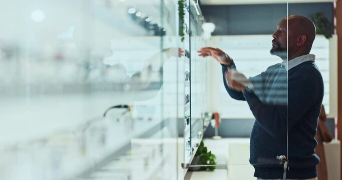 Man, optometry and spectacles as optometrist for eye care, medical professional and consultation in clinic. Male person, glasses and organizing display or ophthalmology center for size, frame or lens