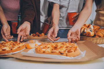 Group of young friends eating pizza.Home party.