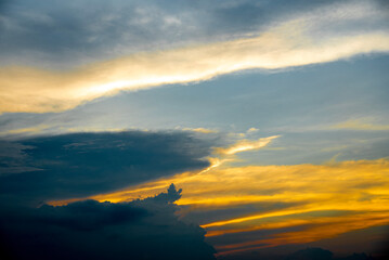 Golden and black clouds in the sky before the sun sets. n, beautiful colorful clouds