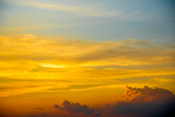 Golden and black clouds in the sky before the sun sets. n, beautiful colorful clouds