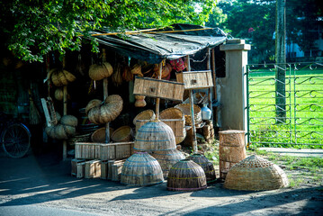  A variety of plastic buckets and woven bamboo baskets are stacked together.stack of wood bucket marcet