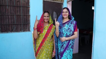 Election in india. Portrait of happy women wearing saree show finger marked with ink after casting vote,Polling Booth Democracy,