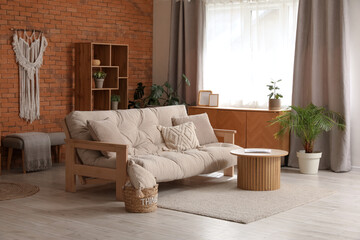 Fototapeta premium Comfortable sofa and coffee table in interior of living room