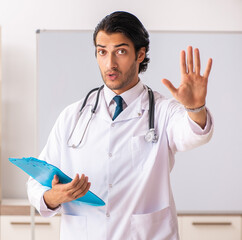 Young doctor in front of whiteboard