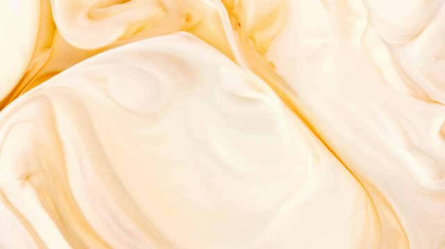 Swirling cream and caramel mixture creating a delightful marbled effect in a bowl