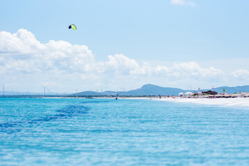 Le Saline beach landscape: turquoise sea meets a distant horizon with faint landforms, under a vast...
