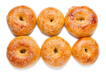 Tasty bagels with sesame seeds on white background