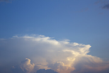 
It is a sunset sky with puffy clouds.