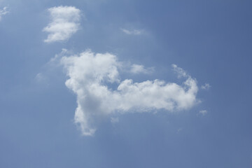 A blue sky with puffy clouds.
