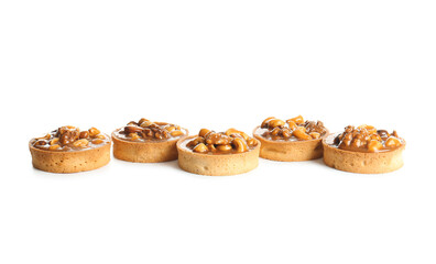 Tasty tarts with nuts and caramel isolated on white background