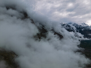 Aerial view of Ultar peak and range part of the Himalayas bellow  covered in clouds,  Hunza Valley, Pakistan