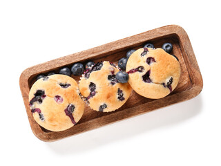 Wooden tray with tasty blueberry muffins on white background, closeup