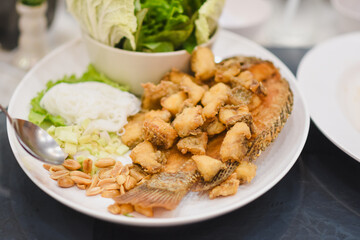 Fried tilapia on a plate on the table