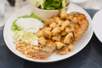 Fried tilapia on a plate on the table