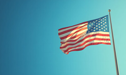 Fototapeta premium American flag. The USA flag blowing in the wind, symbolizing American pride and patriotism. 