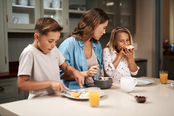 Woman, children and eating breakfast in kitchen for morning routine, nutrition food and bonding together of health. Mother, kids and wellness meal, juice and vitamin c for family growth of house care