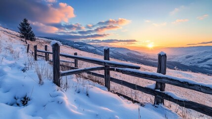 Fototapeta premium Tranquil sunrise over fence in snowy mountains.